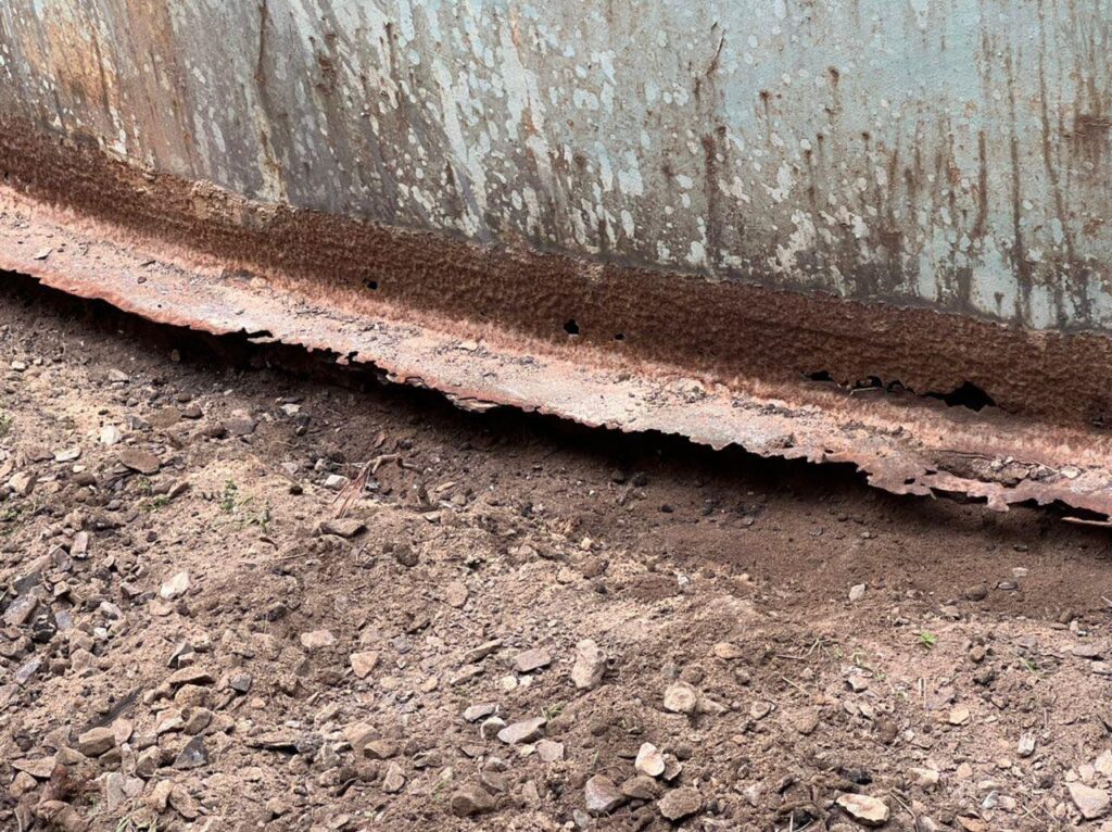 Corroded storage tank before repair